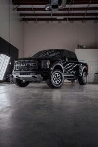 a black truck parked inside of a garage