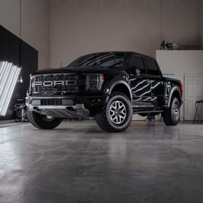 a black truck parked inside of a garage
