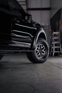 a truck parked inside of a garage next to a ladder