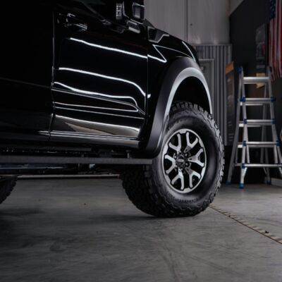 a truck parked inside of a garage next to a ladder